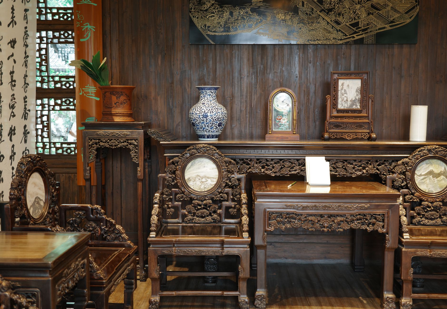 Beautiful Chinese antique furniture in an elegant room with traditional decor and intricate carvings.