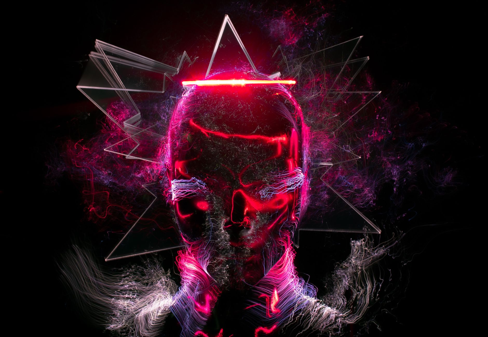 Digital artwork featuring a neon skull with vibrant abstract elements and light effects.